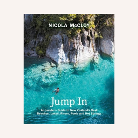 Book cover of 'Jump In: An Insider's Guide to New Zealand's Best Beaches, Lakes, Rivers, Pools and Hot Springs' by Nicola McCloy, featuring a vibrant aerial photograph of turquoise water and rocky cliffs.