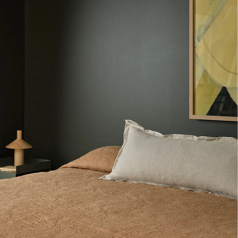 Linden Linen Lumbar Cushion styled on a bed