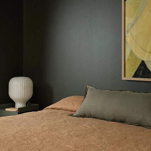 Linden Olive Lumbar Cushion styled on a bed