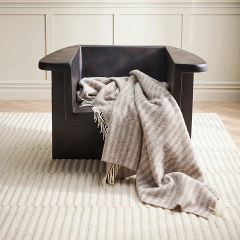 Noah Oatmeal Throw styled on a sofa