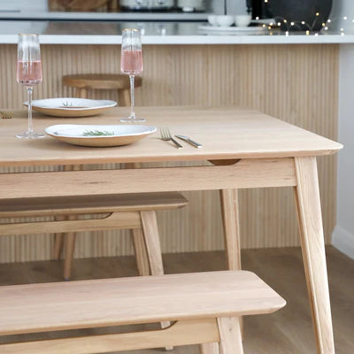 Reuke Dining Table in Natural oak finish styled with matching Reuke bench seat