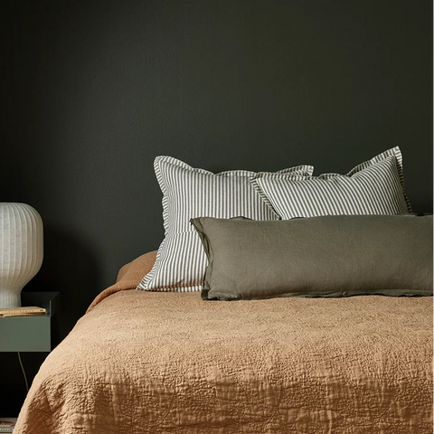 Rowan Olive Cushion styled on bed