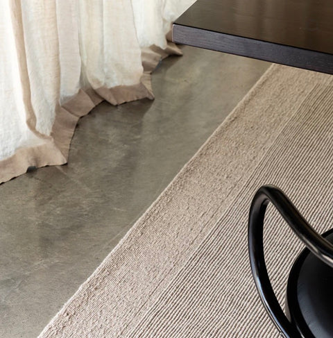wool rug border detail, styled in a contemporary living room
