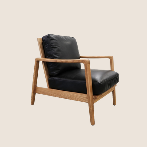 Wanaka Armchair in Black Leather, front view showing brass buckle backrest detail